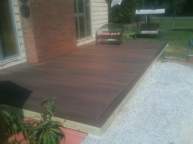 Freshly stained wood deck built against a brick home in Lewisberry
